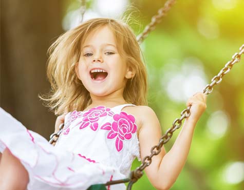 Child on a swing. Westlake by Minto Communities. New homes for sale in Palm Beach County, Florida.