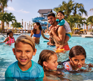 Families playing in pool at Westlake, Minto Communities. New homes for sale in Palm Beach County, Florida.