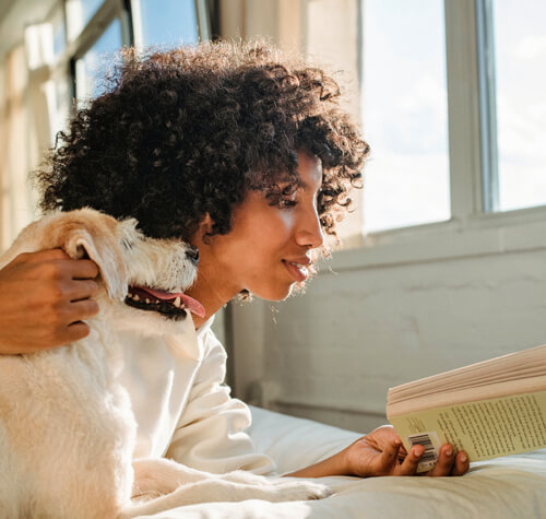 Women reading to her dog in pet-friendly apartments for rent in Glebe, Ottawa