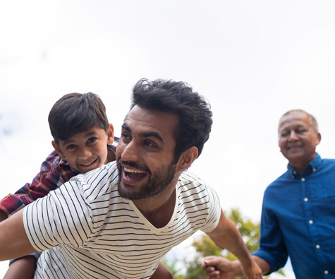 A family playing outside. New homes in Courtice by Minto Communities.