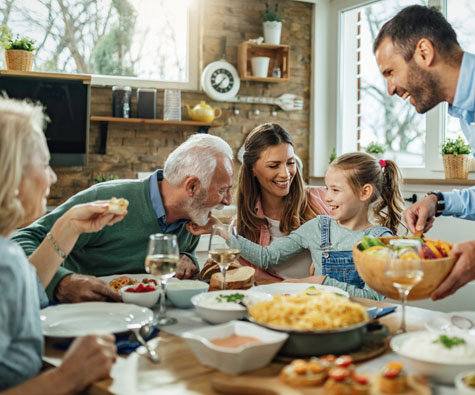 A family sitting down to dinner in Whitby. New homes in Whitby by Minto Communities.