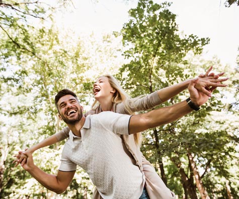 A couple playing in a park in Whitby. New homes in Whitby by Minto Communities.