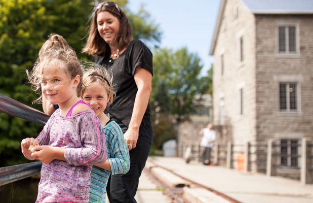 Mother and daughters on a bridge in Manotick Village. 9 Great Reason to Live in Manotick.