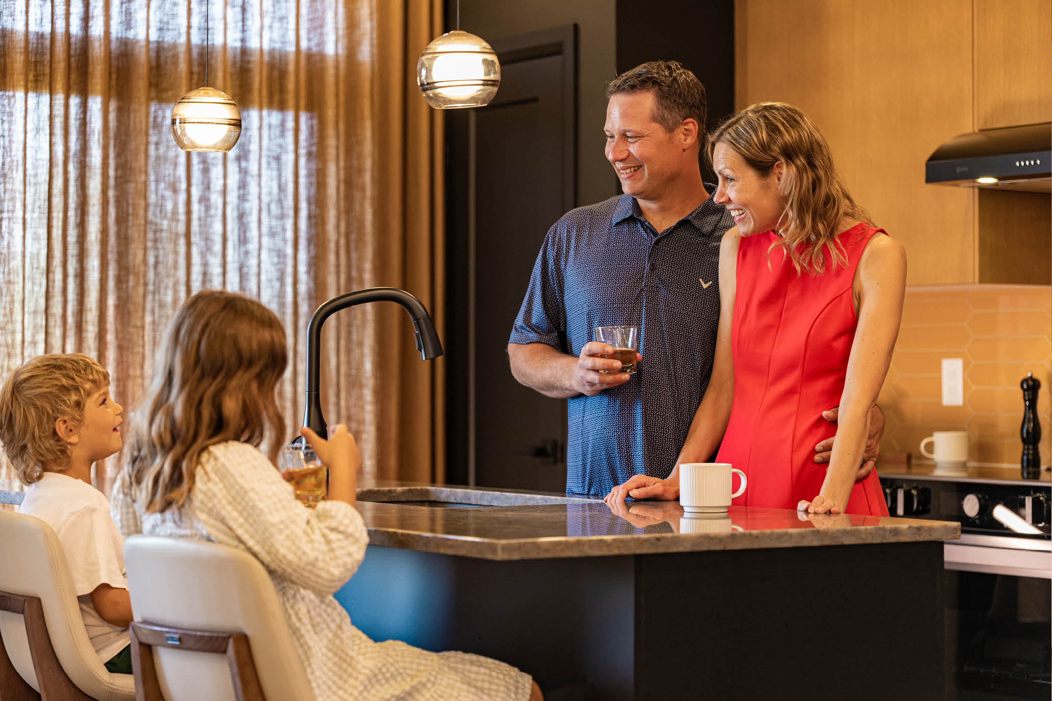 Family inside Executive Townhome kitchen