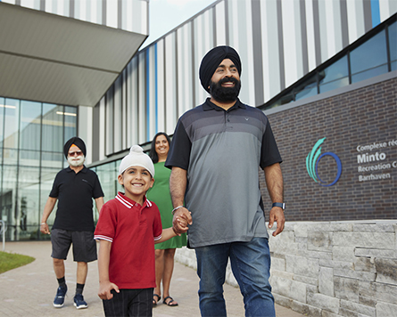Family outside Minto Recreation Centre in Harmony Barrhaven